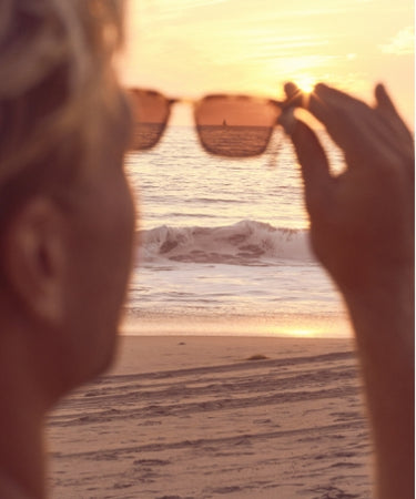 Looking at sunset through sunglasses lens