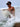 Man surfing with waves crashing around him