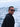Man wearing sunglasses with ocean waves in the background