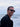 Man wearing sunglasses with a blurred ocean background