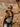 Woman with a backpack and sunglasses in a desert landscape