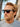 Man wearing sunglasses with a blurred natural background