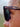Close-up of sunglasses with 'RAEN' brand name on a blurred background