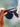 Person holding sunglasses with a blurred natural background