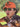 Man wearing an orange cap with 'Metalwoods' branding and sunglasses, outdoors.