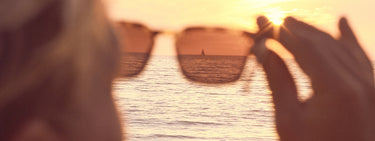 Looking at sunset through sunglasses lens