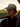 Man wearing a cap and sunglasses with a blurred background