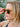 Woman wearing sunglasses with a blurred natural background