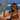 Woman in a bikini holding a green surfboard on a beach