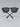 Pair of sunglasses with dark lenses and brown frames on a light gray background