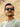Man wearing sunglasses with a blurred natural background