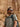 Man wearing sunglasses and a backpack in a desert setting