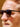 Close-up of a person wearing sunglasses with a blurred background