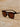 Sunglasses with dark lenses on a sandy surface